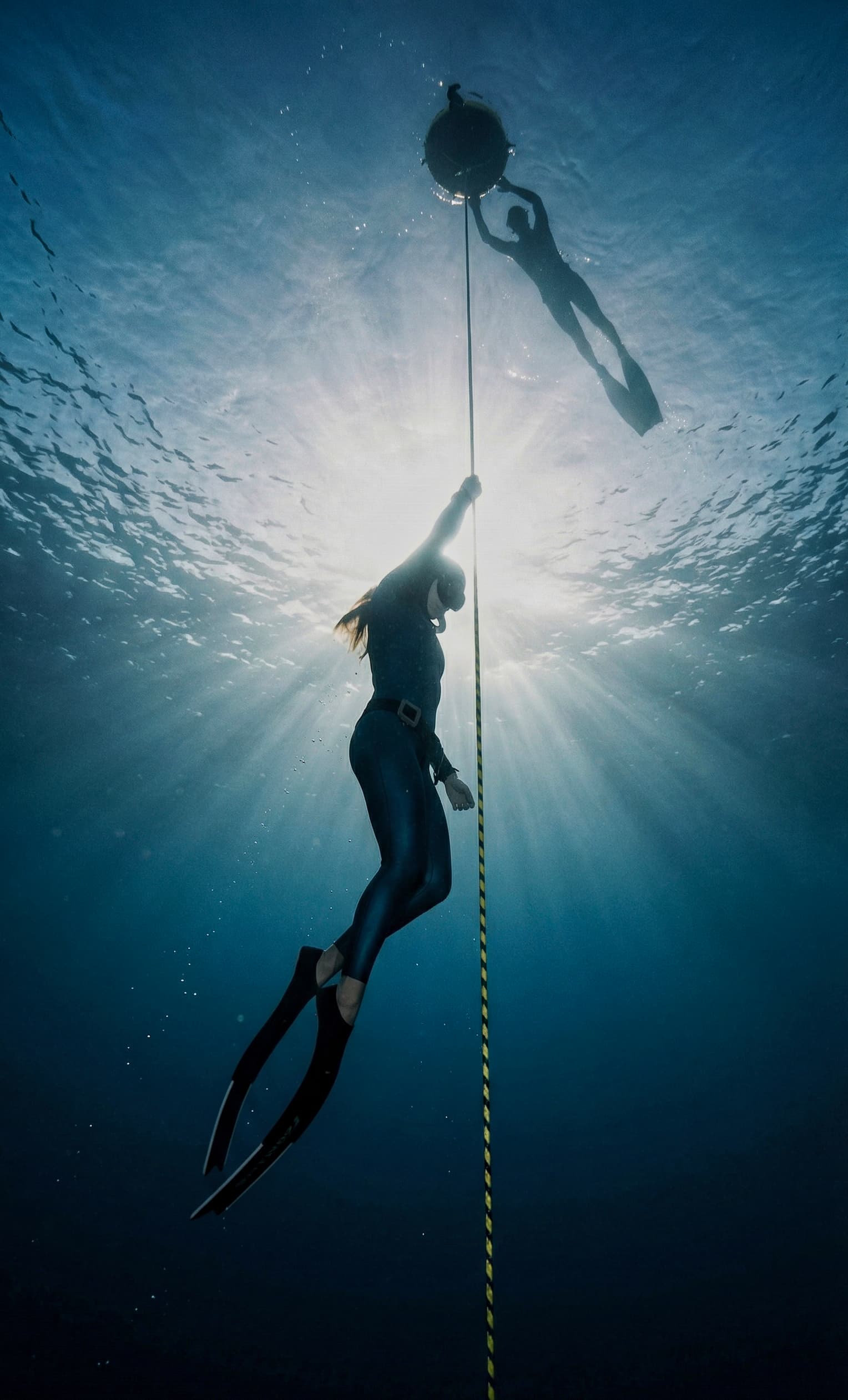 Freediver ascending a training line toward the surface